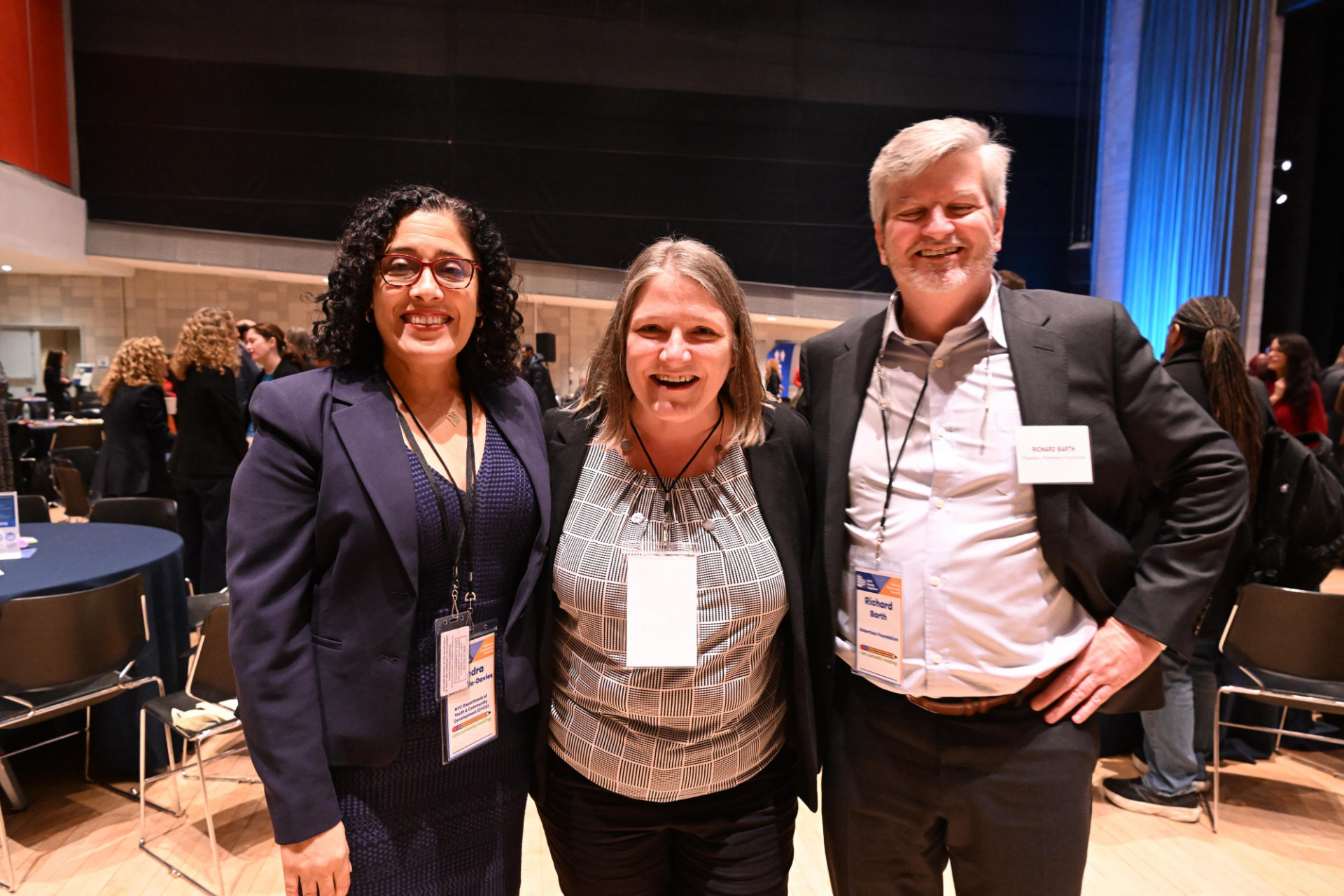 three people smiling