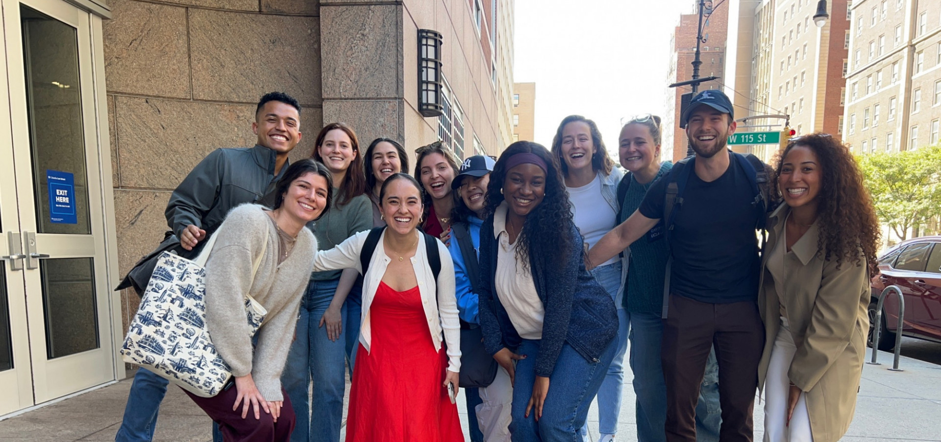 students in the cohort standing side by side outside the classroom building