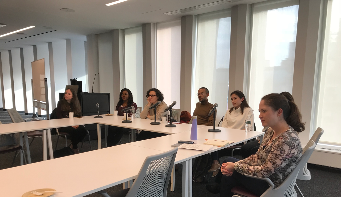 Seven panelists at an event