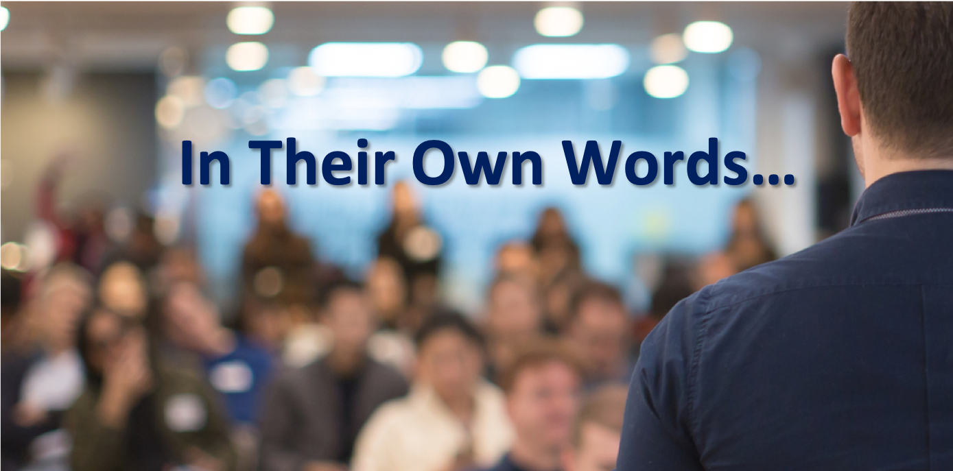 Title card for "In Their Own Words," which features a male presenter facing an audience, which is out of focus. The presenter is preparing to speak. The image also features the title in next two the presenter.