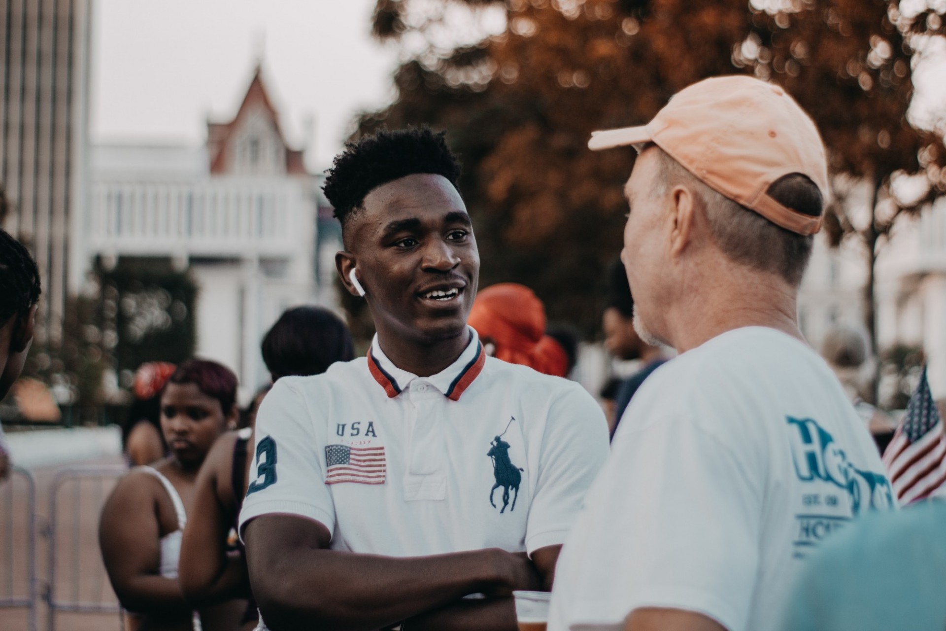 Schools and school systems as participatory democracies Young black male talking with a white male in a city neighborhood