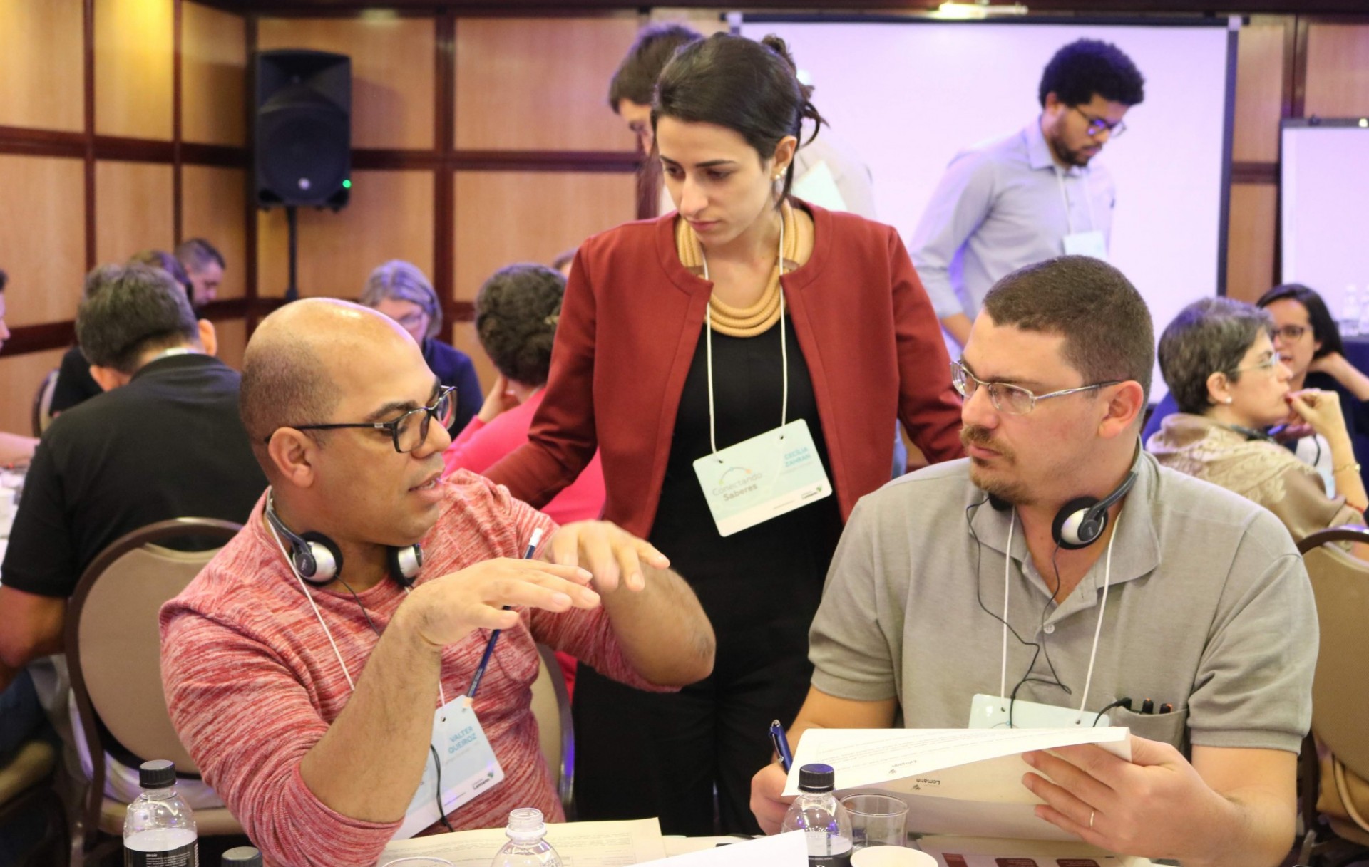 Participants at a workshop talking with a table coach